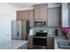 Close-up of the kitchen showcasing granite countertops, stainless steel appliances, and modern finishes at 5317 Radford Loop, Fairburn, GA 30213