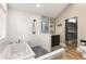 Bathroom featuring a walk-in shower, a soaking tub, a mirror, and a toilet at 290 Georgia Se Ave, Atlanta, GA 30312