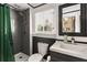 Bathroom with a toilet, sink, vanity, mirror, and shower with gray tile at 290 Georgia Se Ave, Atlanta, GA 30312