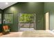 Bedroom featuring green walls, windows, a door to an outdoor deck, and light wood floors at 290 Georgia Se Ave, Atlanta, GA 30312