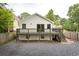 Back of house featuring a deck overlooking a landscaped yard with stone and wood fence at 290 Georgia Se Ave, Atlanta, GA 30312