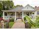 Charming craftsman-style home with inviting front porch, manicured lawn, and pink front door at 290 Georgia Se Ave, Atlanta, GA 30312