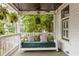 Relaxing front porch with swing, ceiling fan, and decorative pillows with green leafy tree view at 290 Georgia Se Ave, Atlanta, GA 30312