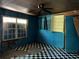 A view of a bedroom needing repairs including damaged walls, damaged floor, and an old ceiling fan at 3008 Grand Sw Ave, Atlanta, GA 30315