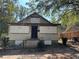 A view of the front exterior showing boarded up windows of a single-story home needing repairs at 3008 Grand Sw Ave, Atlanta, GA 30315