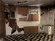 A view of a kitchen needing repairs including missing drywall, boarded up windows, and damaged floors at 3008 Grand Sw Ave, Atlanta, GA 30315