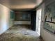 A view of the living room needing repairs including bare walls and damaged flooring at 3008 Grand Sw Ave, Atlanta, GA 30315
