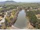Beautiful aerial view of a lake surrounded by trees and houses in the neighborhood at 3275 Aldrich Dr, Cumming, GA 30040