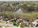 An aerial view of a lakeside residential community surrounded by lush trees, mature landscaping and winding streets at 3275 Aldrich Dr, Cumming, GA 30040