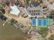 Aerial view of a neighborhood with a pool, tennis courts and lake access at 3275 Aldrich Dr, Cumming, GA 30040