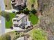 An aerial view of a home showcasing its lush green lawn, landscape design, and architectural roof details at 3275 Aldrich Dr, Cumming, GA 30040