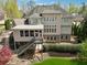 Aerial view of backyard and home featuring an outdoor living space and wooded lot at 3275 Aldrich Dr, Cumming, GA 30040