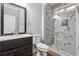 Modern bathroom featuring a dark wood vanity and a shower with sliding glass doors at 3275 Aldrich Dr, Cumming, GA 30040