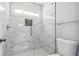 Modern glass shower stall with marble-like tile and hexagonal floor tiles at 3275 Aldrich Dr, Cumming, GA 30040