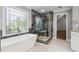 Well-appointed bathroom with a glass shower, soaking tub, and elegant window, offering a spa-like experience at 3275 Aldrich Dr, Cumming, GA 30040