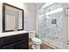 Modern bathroom with a glass shower door and a dark wood vanity with marble countertops at 3275 Aldrich Dr, Cumming, GA 30040