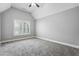 Bright bedroom featuring neutral walls, plush carpeting, and a vaulted ceiling with a fan at 3275 Aldrich Dr, Cumming, GA 30040