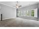 Spacious bedroom features neutral walls, plush carpeting, and windows overlooking the yard at 3275 Aldrich Dr, Cumming, GA 30040