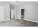 Spacious bedroom featuring neutral walls, carpeted floors, and doorways to other rooms at 3275 Aldrich Dr, Cumming, GA 30040