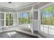 Bright bedroom featuring a wall of windows with views and white shutters that filter soft natural light at 3275 Aldrich Dr, Cumming, GA 30040