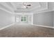 Spacious bedroom with tray ceiling, ceiling fan, and large windows with shutters for ample natural light at 3275 Aldrich Dr, Cumming, GA 30040