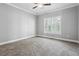 Bright bedroom with large window and neutral walls, featuring a ceiling fan for added comfort and climate control at 3275 Aldrich Dr, Cumming, GA 30040