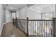 Hallway with wrought iron railing and hardwood floors at 3275 Aldrich Dr, Cumming, GA 30040
