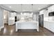 Bright kitchen boasts a large island, stainless steel appliances, and ample white cabinetry at 3275 Aldrich Dr, Cumming, GA 30040