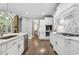 Open kitchen showcases stainless steel appliances, white cabinets, and marble countertops at 3275 Aldrich Dr, Cumming, GA 30040