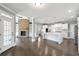 Open concept kitchen with marble countertops, stone fireplace, and stainless appliances at 3275 Aldrich Dr, Cumming, GA 30040