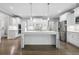 Open kitchen showcases stainless appliances, white cabinetry, and large island at 3275 Aldrich Dr, Cumming, GA 30040