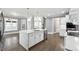 Bright kitchen features a large island, stainless appliances, and fireplace view at 3275 Aldrich Dr, Cumming, GA 30040