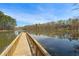 Wooden pier on a tranquil lake with trees and sky reflecting in the water at 3275 Aldrich Dr, Cumming, GA 30040