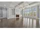 Spacious living room featuring a fireplace, built-in shelves, a coffered ceiling, and plenty of natural light at 3275 Aldrich Dr, Cumming, GA 30040
