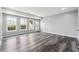 Large living room with three windows for natural light and access to the outside at 3275 Aldrich Dr, Cumming, GA 30040