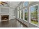 Cozy living room with fireplace, built-in bookshelves, hardwood floors, and large windows with water views at 3275 Aldrich Dr, Cumming, GA 30040