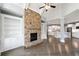 Spacious living room featuring a stone fireplace, built-in bookshelves, and hardwood floors at 3275 Aldrich Dr, Cumming, GA 30040