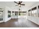 Covered patio with wood flooring, paneled walls, and a bar, perfect for outdoor entertaining at 3275 Aldrich Dr, Cumming, GA 30040