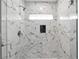 Modern walk-in shower featuring stunning marble-patterned tile and glass door at 3275 Aldrich Dr, Cumming, GA 30040
