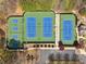 Aerial view of community tennis courts with blue and green surfaces surrounded by lush trees and parking at 3275 Aldrich Dr, Cumming, GA 30040