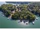 Aerial view of a lakefront property, showcasing lush trees, a private dock, and the serene water at 6160 Lake Lanier Heights Rd, Buford, GA 30518
