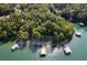 Lush aerial view of waterfront property with docks and lake access nestled among trees at 6160 Lake Lanier Heights Rd, Buford, GA 30518