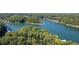 Expansive aerial view of a lake surrounded by dense forest, highlighting the natural beauty at 6160 Lake Lanier Heights Rd, Buford, GA 30518