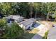 High aerial view highlighting home, driveway, and surrounding trees near the lake at 6160 Lake Lanier Heights Rd, Buford, GA 30518