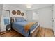 Stylishly decorated bedroom with a rustic bed frame, unique mirror, and hardwood floors at 6160 Lake Lanier Heights Rd, Buford, GA 30518