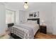Bright bedroom with a double bed, side table, and a view to the outdoor scenery at 6160 Lake Lanier Heights Rd, Buford, GA 30518