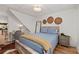 Comfortable bedroom featuring a rustic bed, accent decor and hardwood floors throughout at 6160 Lake Lanier Heights Rd, Buford, GA 30518