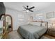 Bright bedroom with plush comforter, hardwood floors, and a full-length mirror at 6160 Lake Lanier Heights Rd, Buford, GA 30518