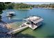 Beautiful boat dock with a sun deck, stairs to the water, and lush greenery, perfect for enjoying the lake life at 6160 Lake Lanier Heights Rd, Buford, GA 30518