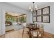 Bright breakfast nook with access to the covered patio, light hardwood floors, and unique table with glass top at 6160 Lake Lanier Heights Rd, Buford, GA 30518